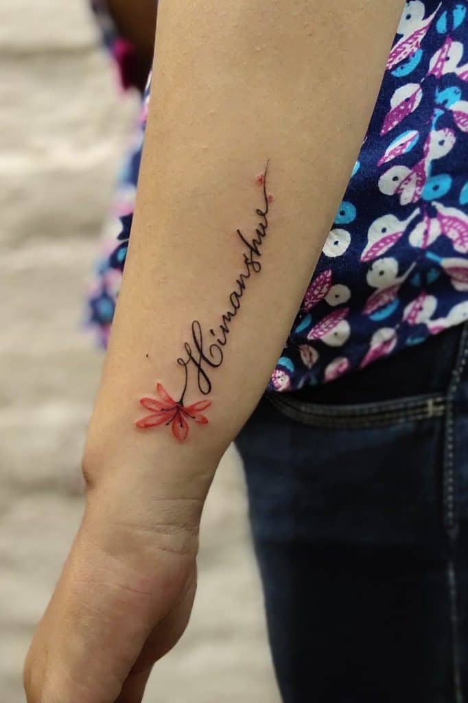 名前の前腕の赤いバラのタトゥー