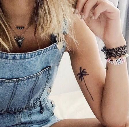 Palmės tatuiruotė ant merginos rankos.