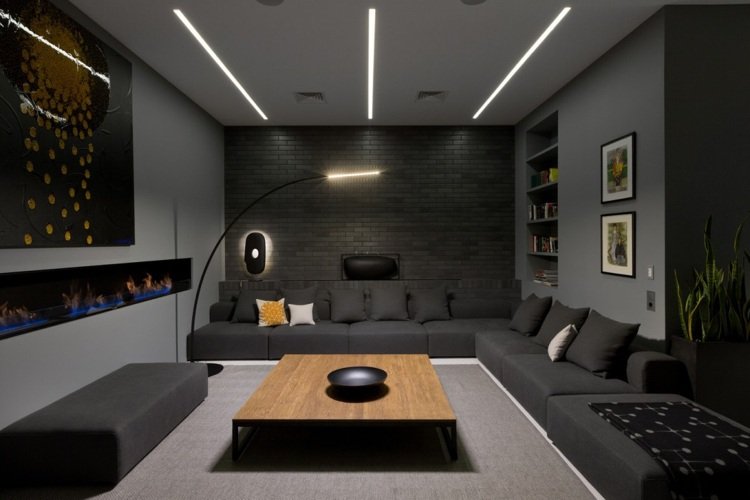 Culoare antracit și perete de cărămidă în camera de zi modernă Culoare antracit -apartament modern la ultimul etaj-cameră de zi-canapea-colț canapea-lampă-cărămidă clincher