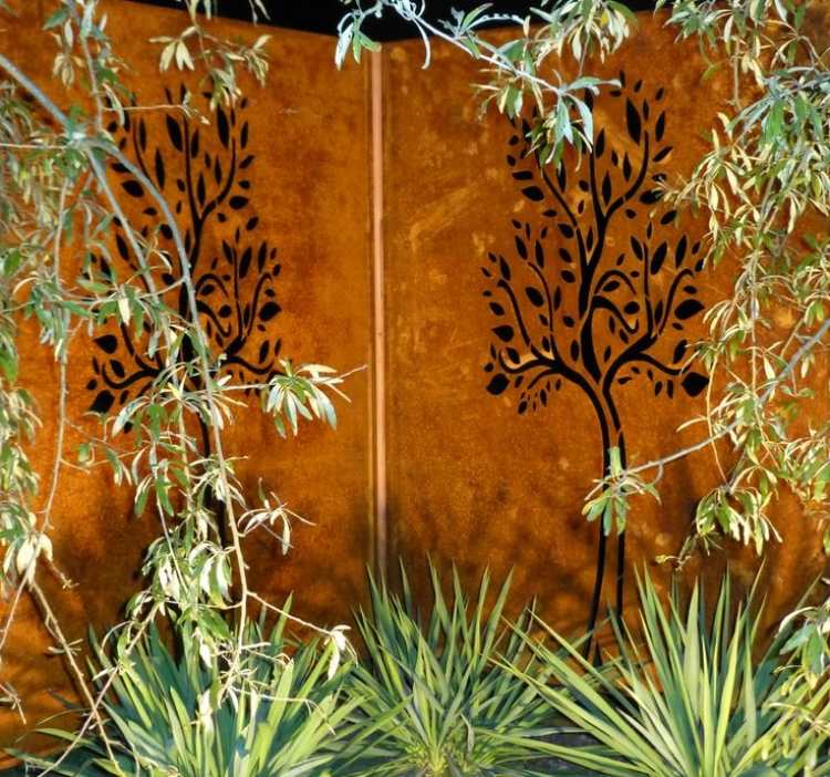 perete din oțel corten maro-portocaliu în armonie cu plantele verzi ecran de confidențialitate din oțel corten motiv de copac de grădină tăiat cu laser