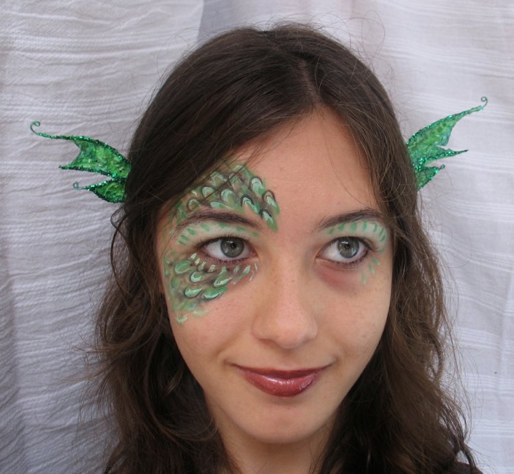 femeie care machiază machiajul ochii dragonului se formează verde
