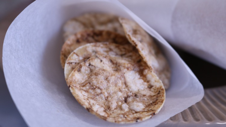 chipsuri de orez într-o pungă de hârtie făcută din hârtie de copt pentru o petrecere cu mâncare cu degetul