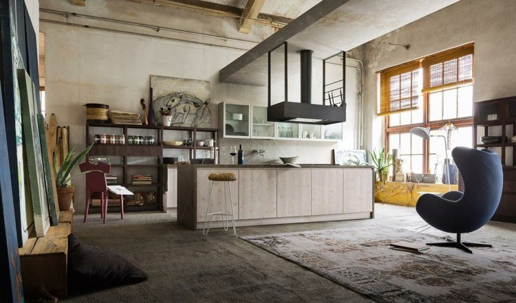 mansardă stil industrial beton fotoliu zonă de gătit insulă hota aragaz oțel