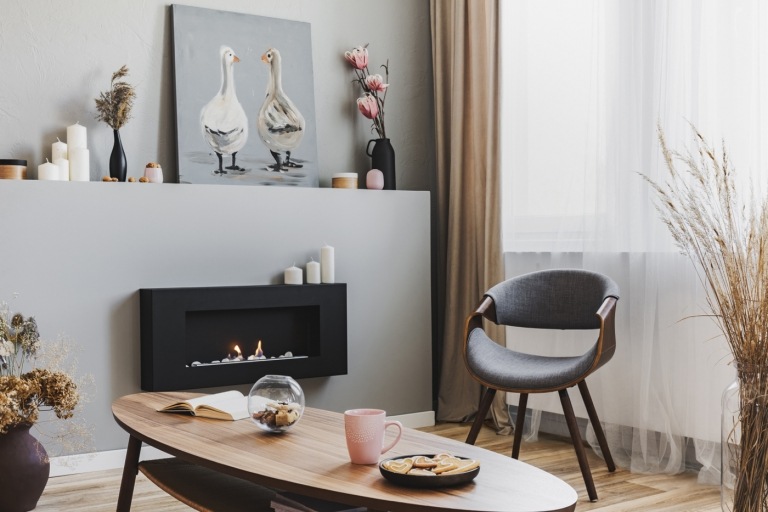 Cumpărați mobilier online pentru a amenaja un mic living cu șemineu pe gaz și fotoliu de designer în stil retro