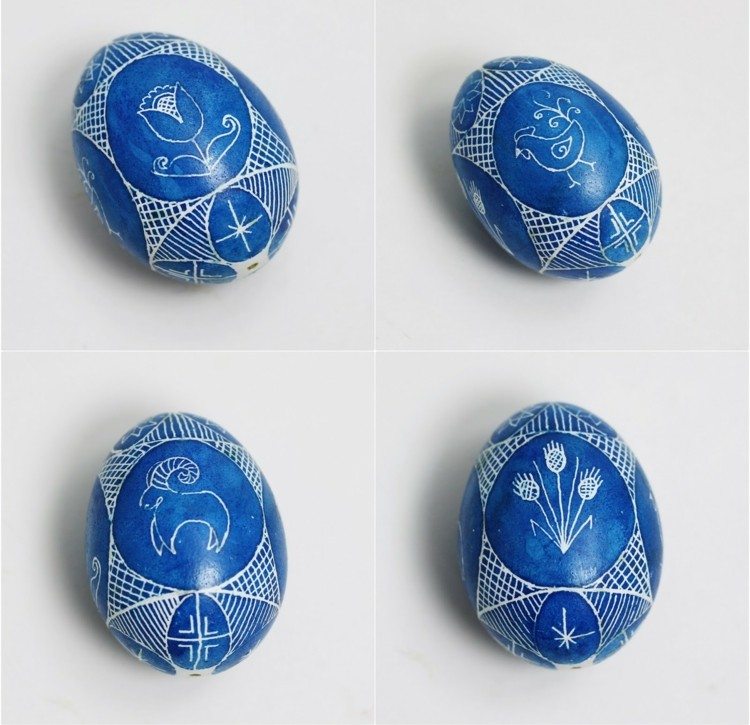 Ouă de Paște albastru închis cu modele albe ouă de Paște-ceară-decorează-motive-albastre-capricorn-flori-cocoș