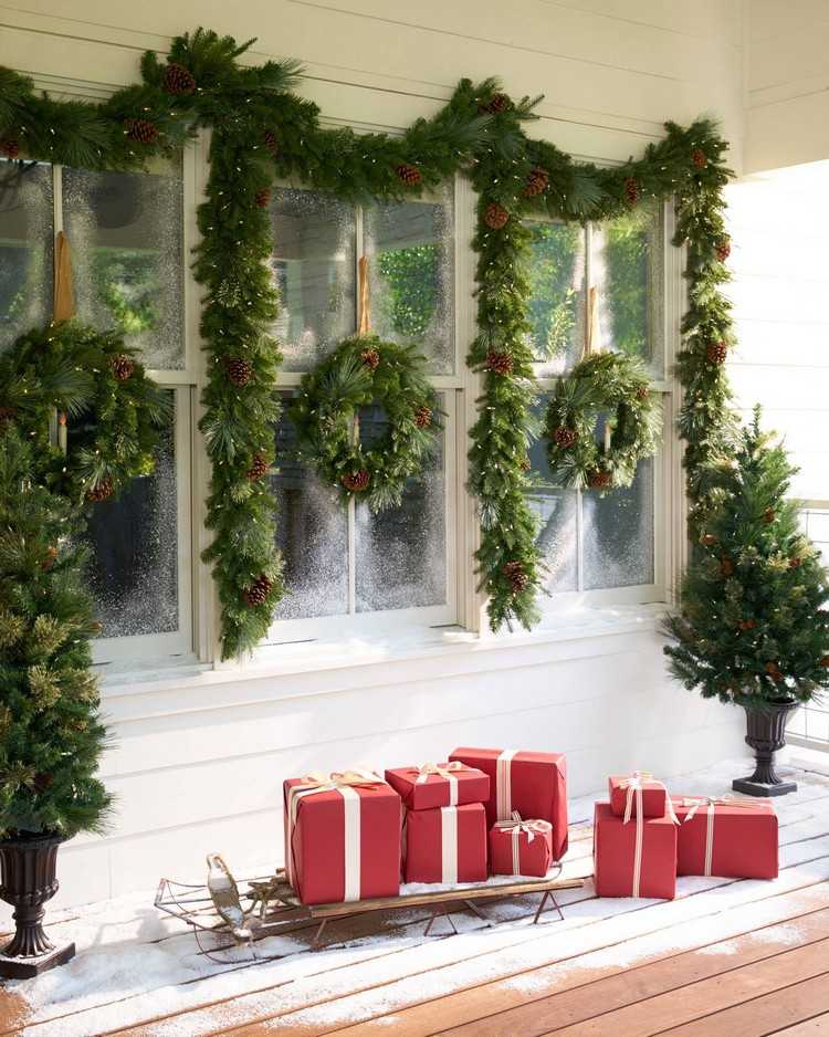 intrarea casei decora ghirlandele de Crăciun coroane cu sania cadouri