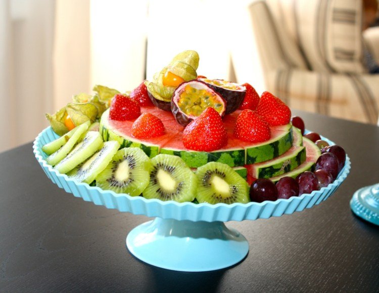 Pepeni în optimi pe un suport de tort, decorat cu fructe de sezon