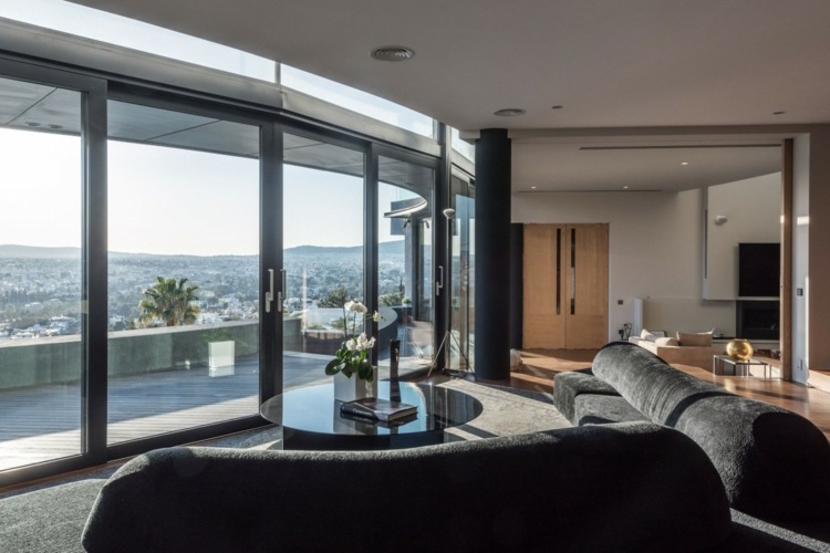 Din zona de relaxare a sufrageriei negre puteți privi în jos în cea inferioară sufragerie apartament gri negru zonă de relaxare design skyline athens